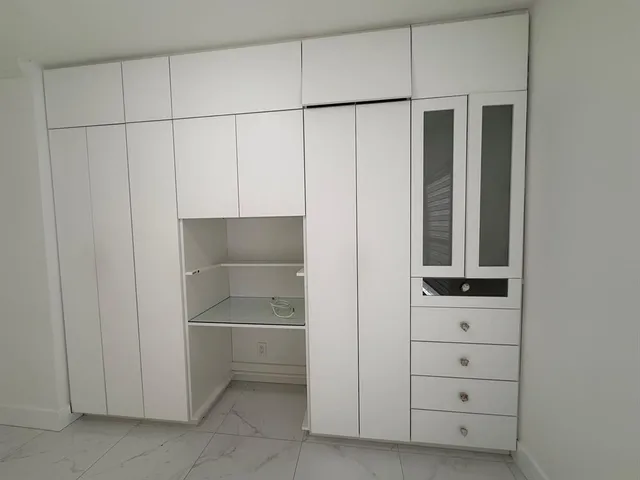 a bedroom with a bed and a potted plant