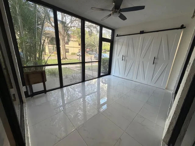 a view of a white house with a yard