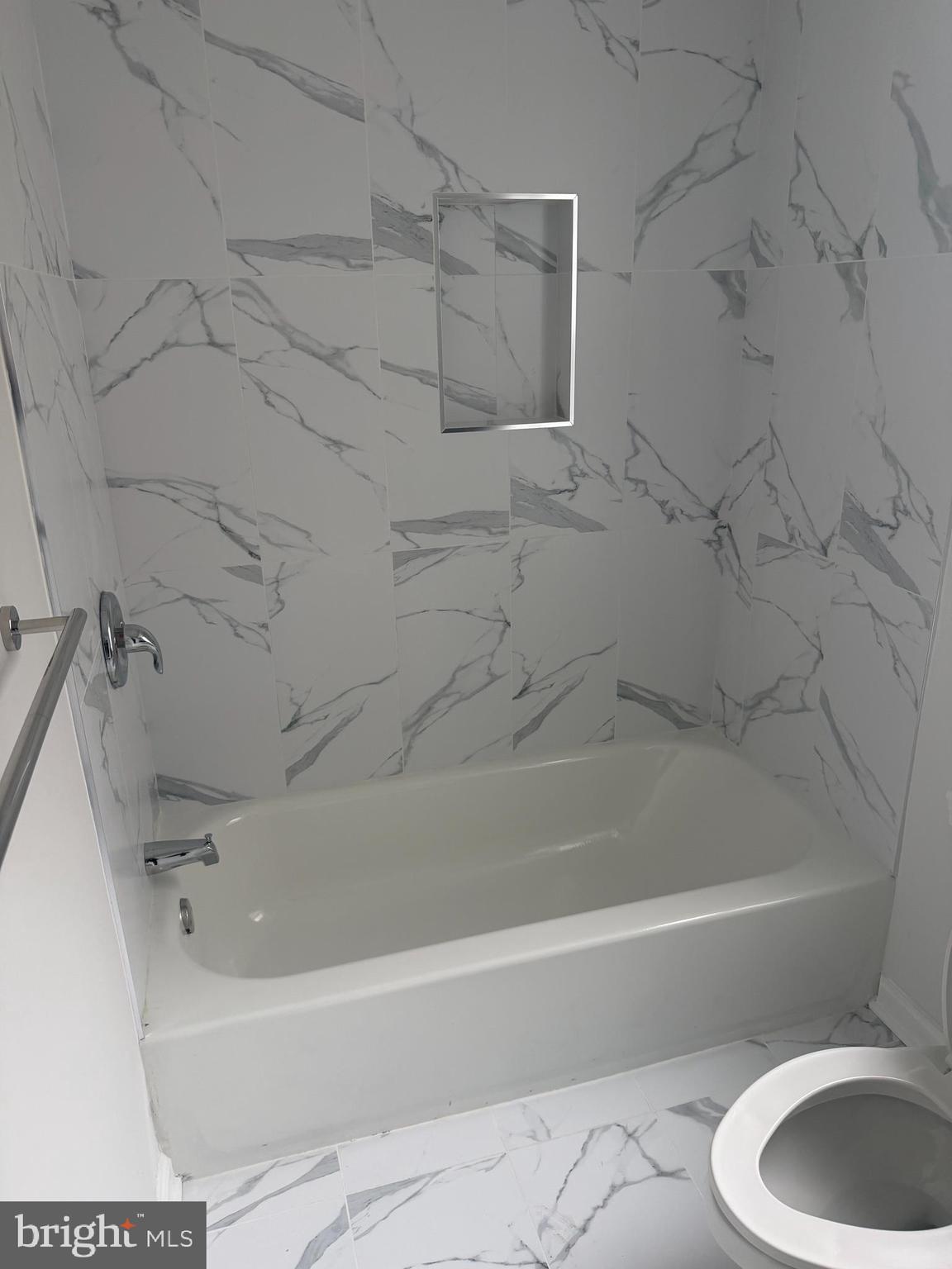 112 East Huntingdon Street, Unit 2 Philadelphia, PA 19125 - Photo 11 of 12 a white bath tub sitting next to a white sink and vanity