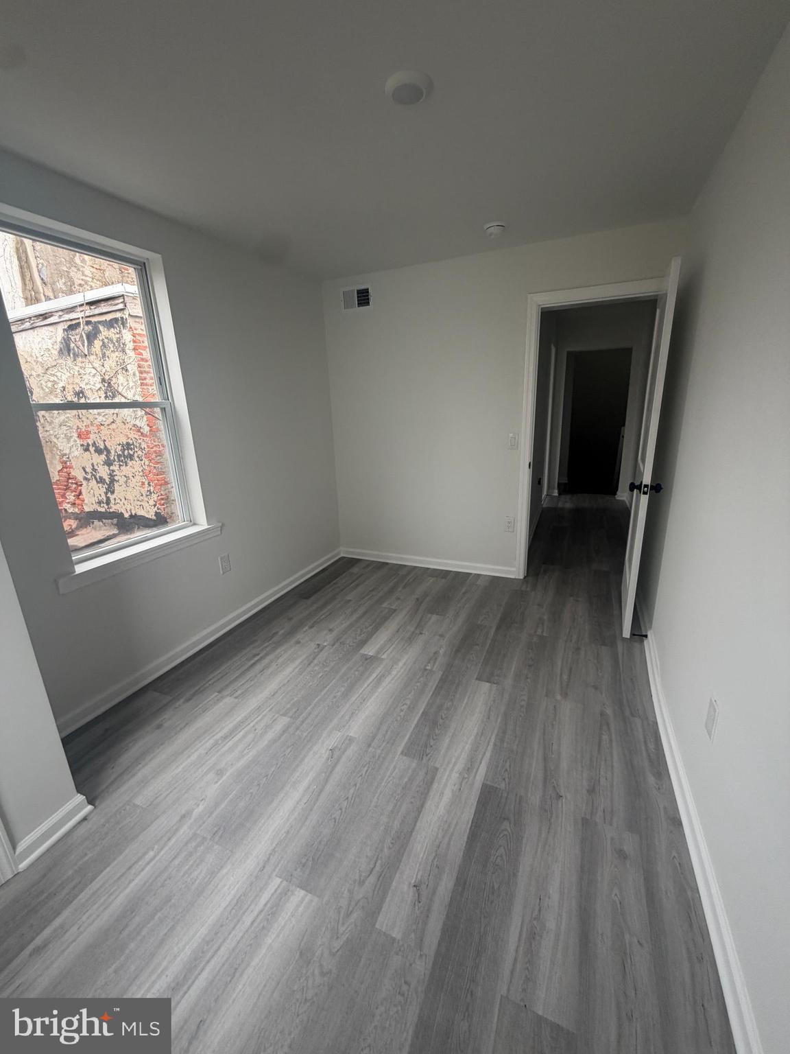 112 East Huntingdon Street, Unit 2 Philadelphia, PA 19125 - Photo 12 of 12 an empty room with wooden floor and windows