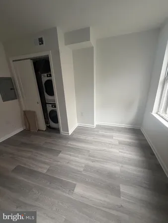 an empty room with wooden floor and stairs