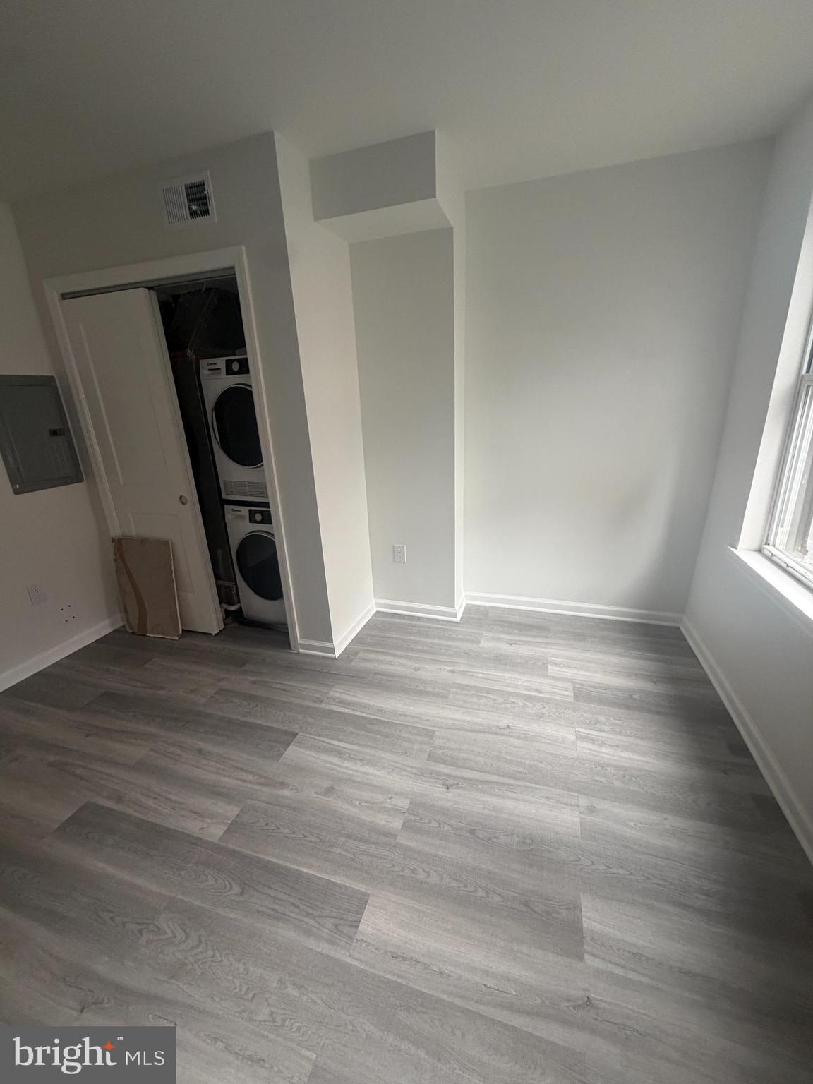 112 East Huntingdon Street, Unit 2 Philadelphia, PA 19125 - Photo 3 of 12 an empty room with wooden floor and stairs