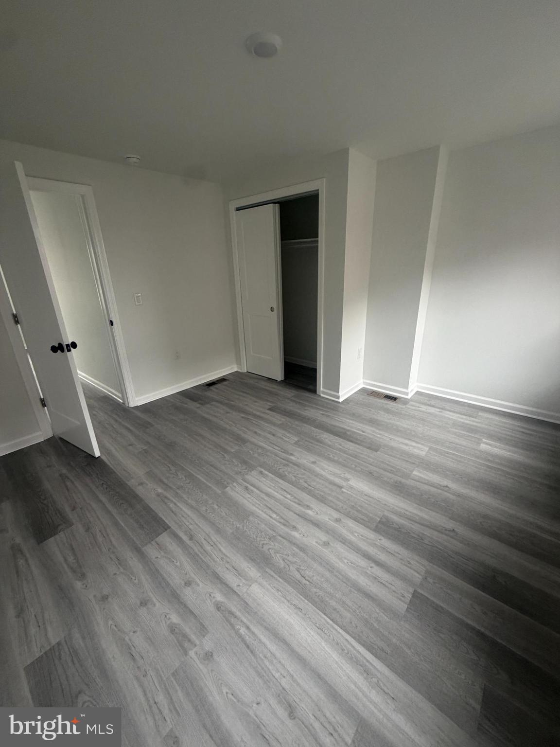 112 East Huntingdon Street, Unit 2 Philadelphia, PA 19125 - Photo 5 of 12 a view of an empty room with wooden floor and a window