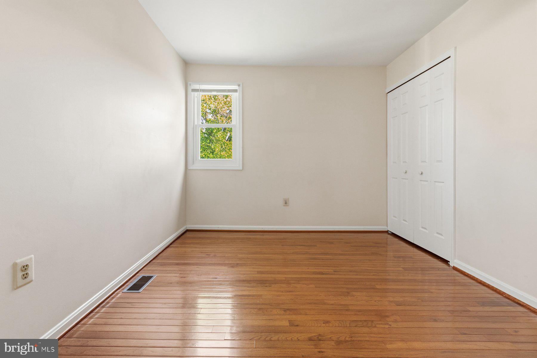 14215 Greenview Drive Laurel, MD 20708 - Photo 25 of 35 a view of an empty room with wooden floor and a window