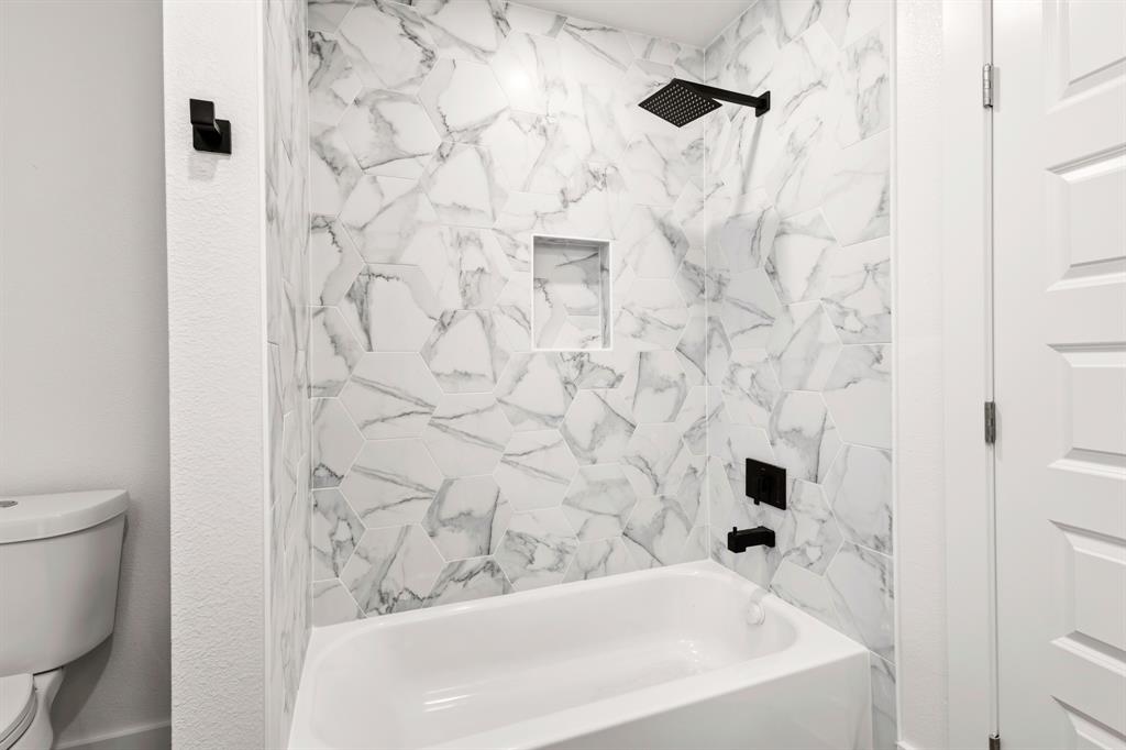 413 North Patton Avenue Dallas, TX 75203 - Photo 16 of 21 a bathroom with a bathtub and a shower
