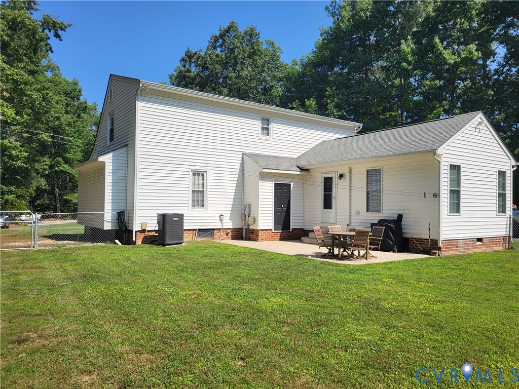 13521 Bailey Bridge Road Midlothian, VA 23112 - Photo 5 of 9 White vinyl siding exterior with an attached patio