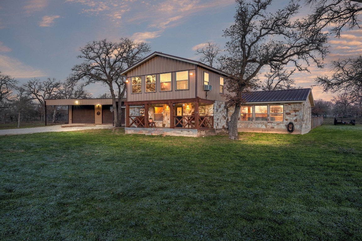 a front view of house with yard and green space