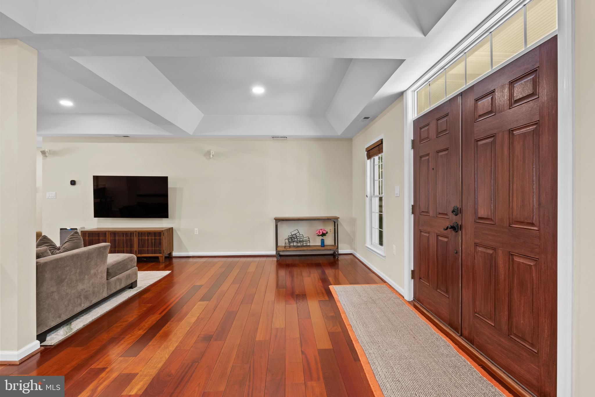 11019 Ring Road Reston, VA 20190 - Photo 4 of 78 a living room with a flat screen tv on dresser and a wooden floor