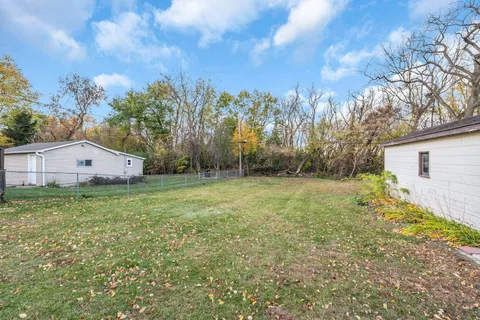 a view of a backyard with large trees