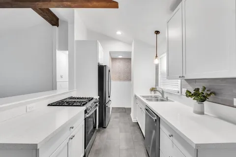 a kitchen with a sink stove and refrigerator