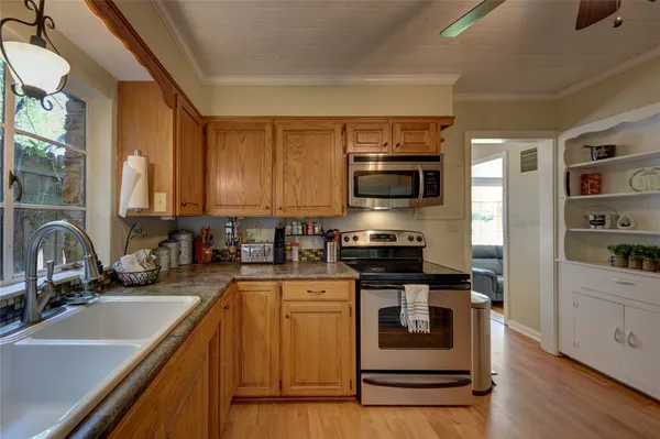 a kitchen with a sink stove and microwave