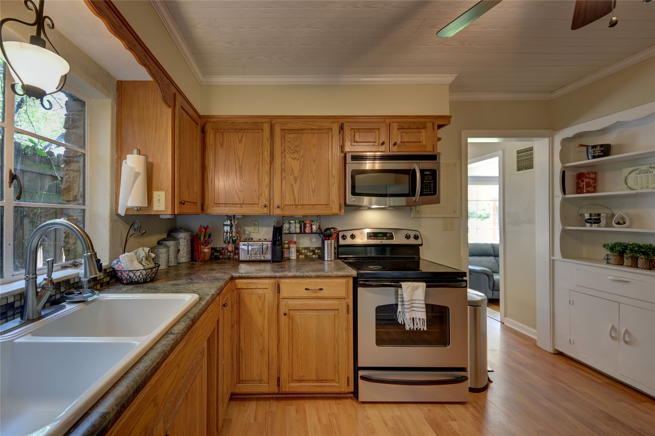 706 South Market Street Brenham, TX 77833 - Photo 11 of 27 a kitchen with a sink stove and microwave
