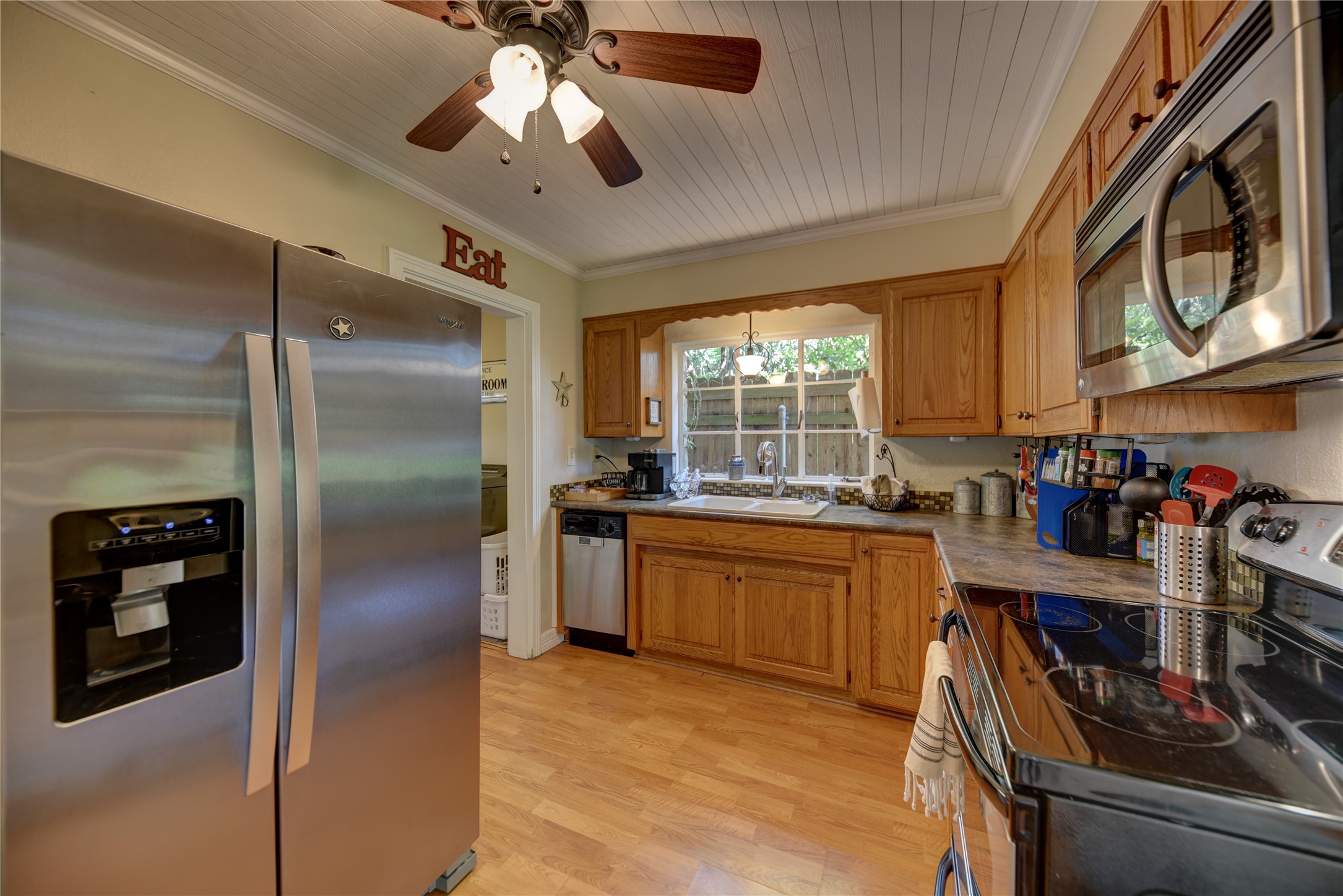 706 South Market Street Brenham, TX 77833 - Photo 12 of 27 a kitchen with stainless steel appliances granite countertop a refrigerator a stove and a sink with cabinets