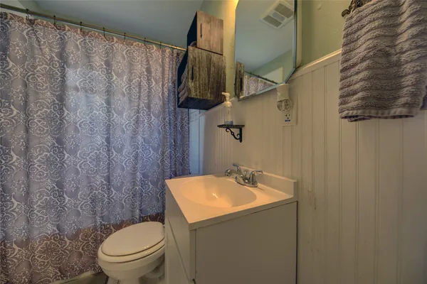 a bathroom with a toilet sink and shower