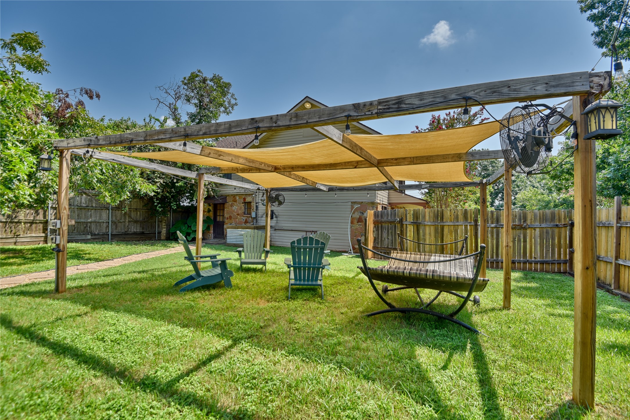 706 South Market Street Brenham, TX 77833 - Photo 25 of 27 a backyard of a house with barbeque oven table and chairs