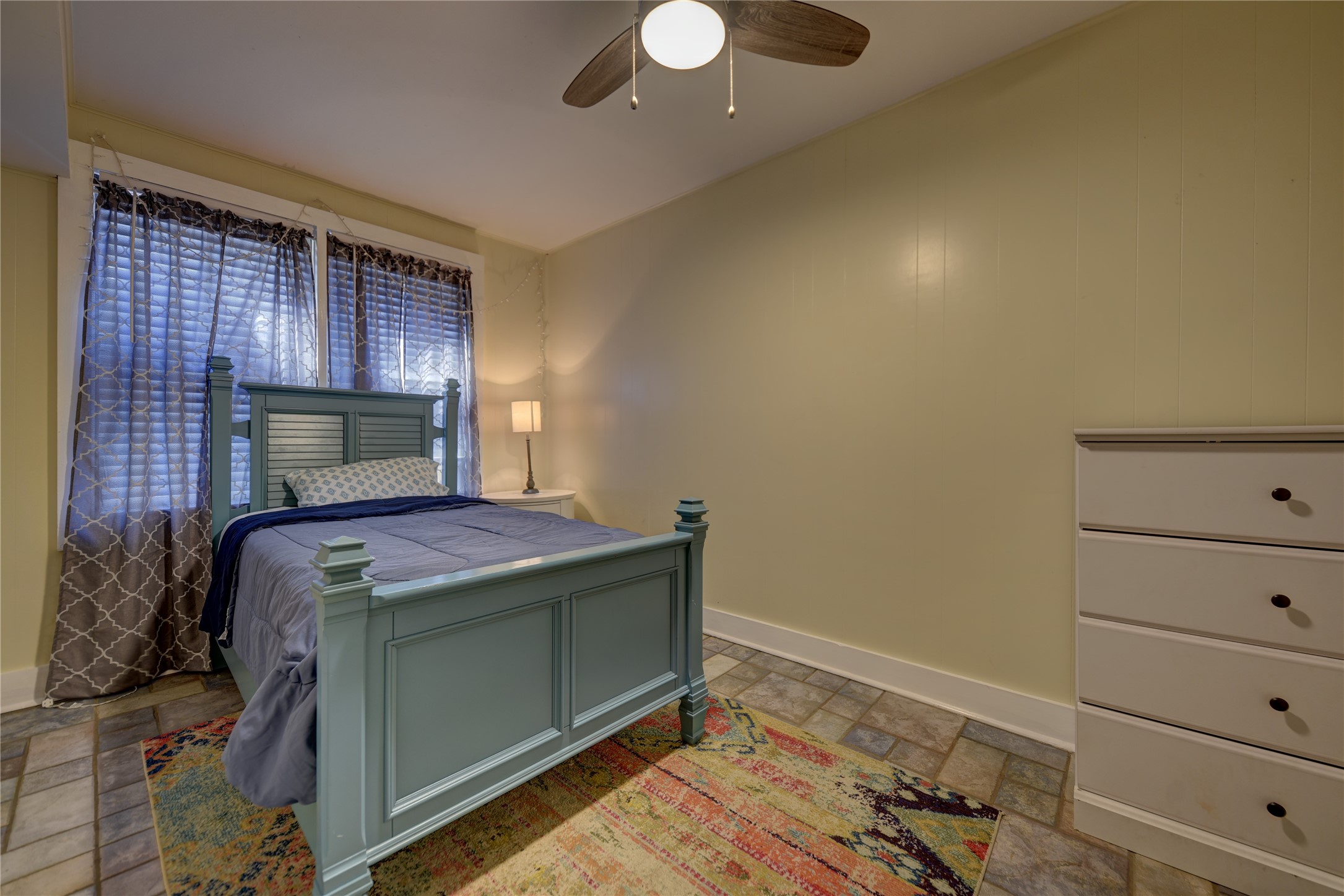 706 South Market Street Brenham, TX 77833 - Photo 9 of 27 a room with a bed and lamp