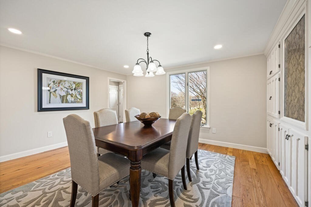18 Philip Road Lexington, MA 02421 - Photo 12 of 38 a dining room with furniture a rug and wooden floor
