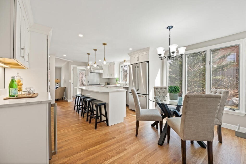 18 Philip Road Lexington, MA 02421 - Photo 14 of 38 a dining room with stainless steel appliances kitchen island granite countertop a dining table chairs and a refrigerator