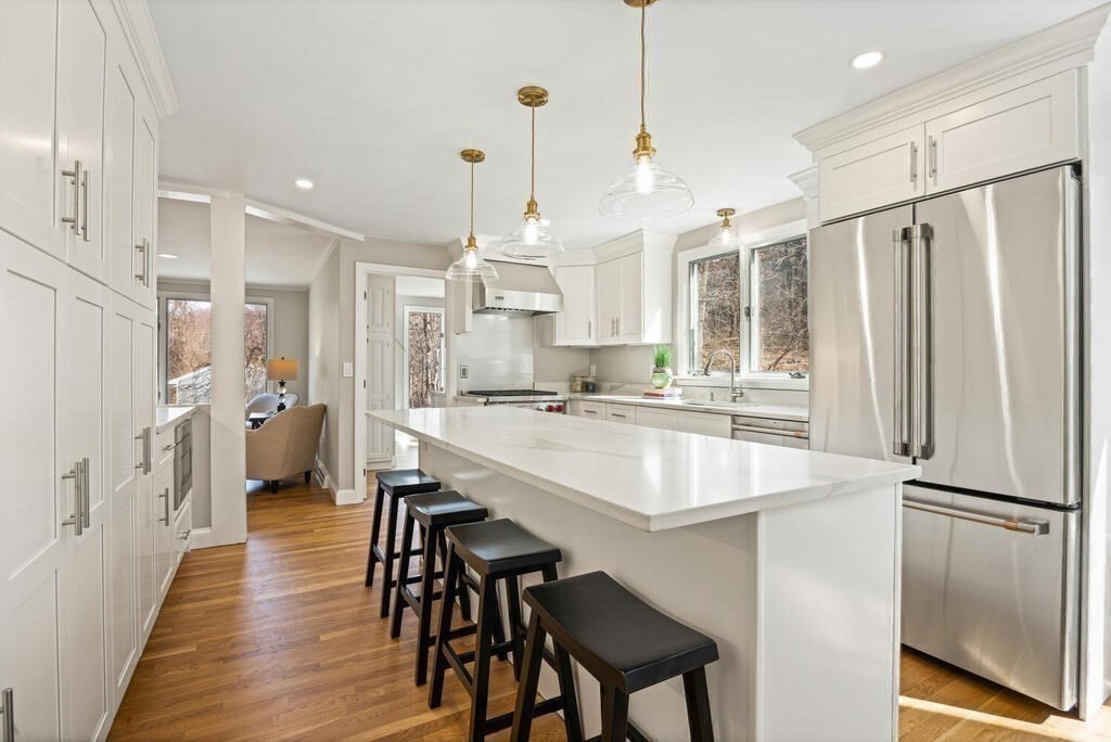 18 Philip Road Lexington, MA 02421 - Photo 16 of 38 a large kitchen with a table chairs refrigerator and cabinets