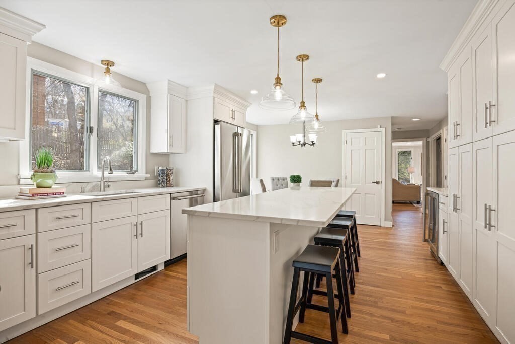 18 Philip Road Lexington, MA 02421 - Photo 17 of 38 a large kitchen with kitchen island white cabinets and stainless steel appliances