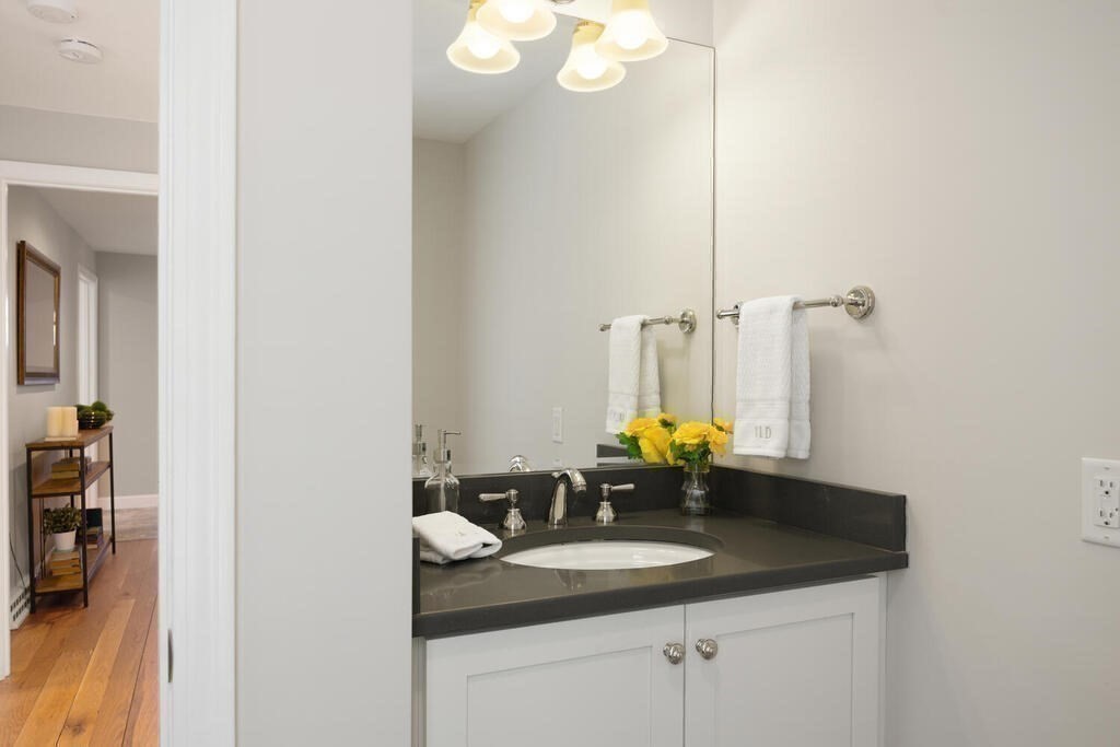 18 Philip Road Lexington, MA 02421 - Photo 19 of 38 a bathroom with a granite countertop sink and a mirror