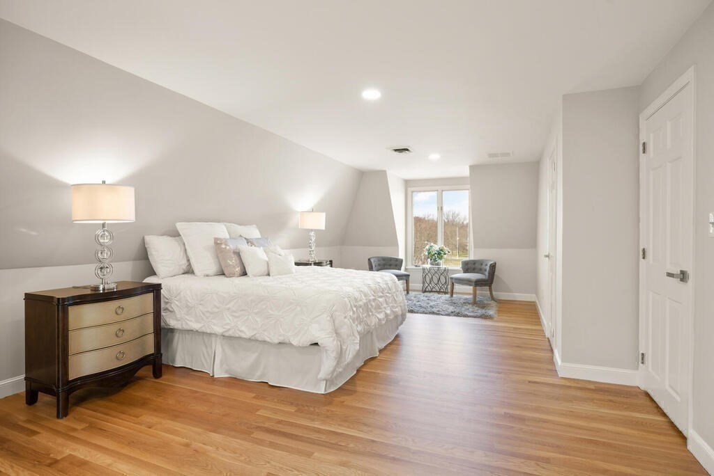 18 Philip Road Lexington, MA 02421 - Photo 25 of 38 a spacious bedroom with a bed and a table