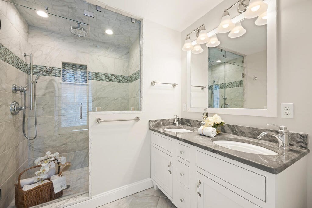 18 Philip Road Lexington, MA 02421 - Photo 27 of 38 a bathroom with a granite countertop sink a shower and a mirror