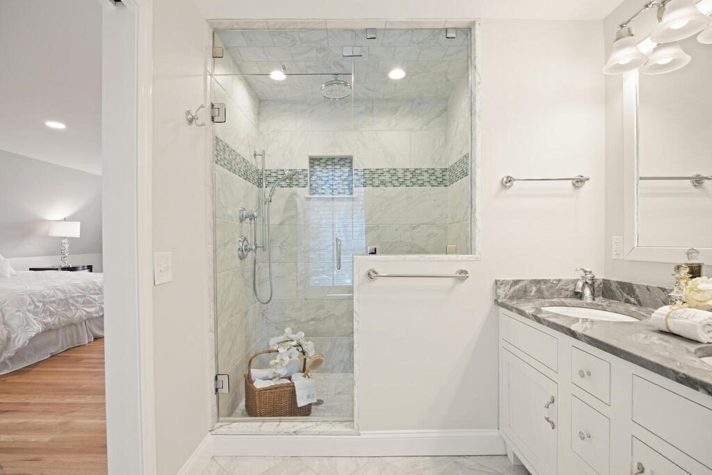 18 Philip Road Lexington, MA 02421 - Photo 28 of 38 a bathroom with a granite countertop sink mirror and shower