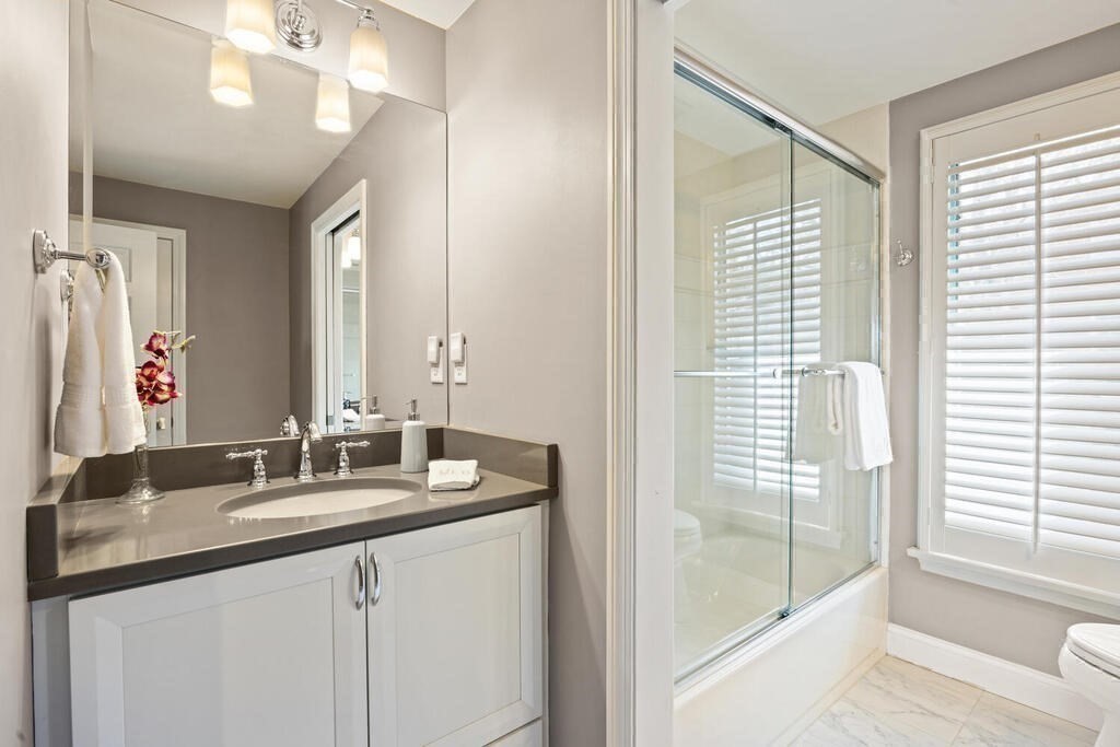 18 Philip Road Lexington, MA 02421 - Photo 32 of 38 a bathroom with a double vanity sink and a mirror