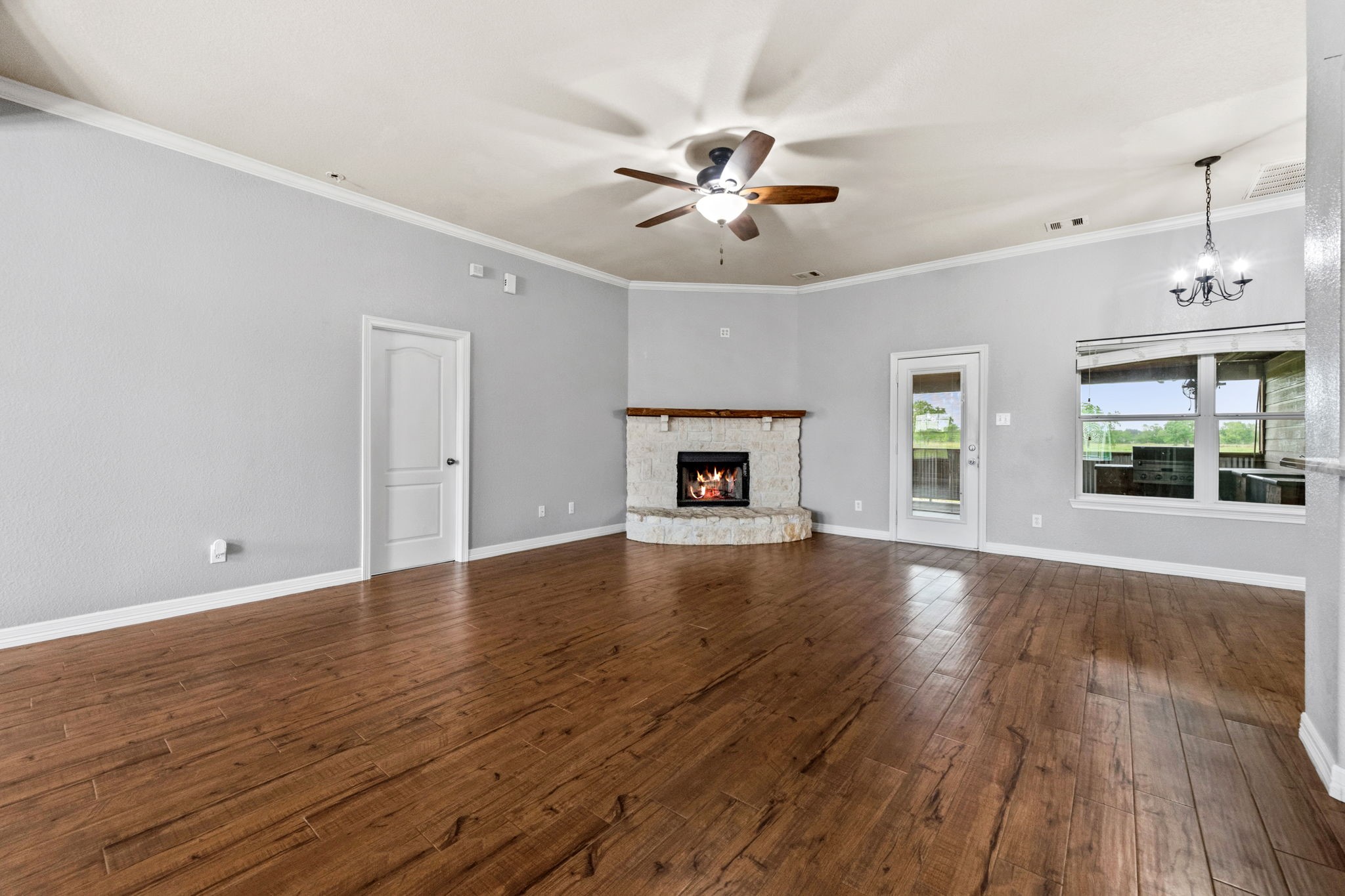 1405 Big Hill Road Winnie, TX 77665 - Photo 21 of 43 a view of empty room with wooden floor and fan