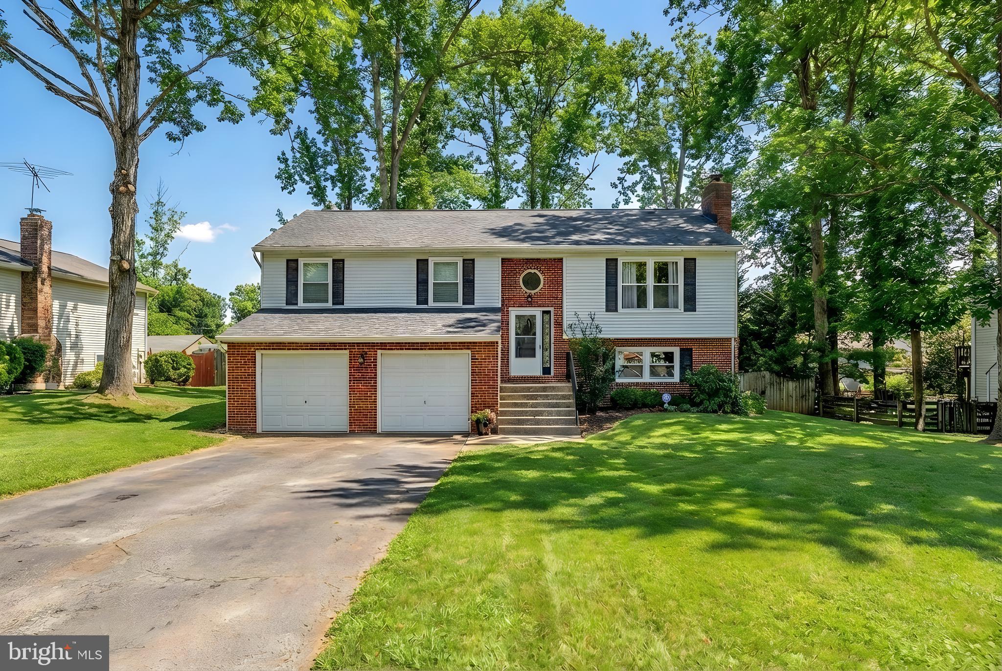228 Choptank Road Stafford, VA 22556 - Photo 1 of 56 a view of a house with a big yard and large trees