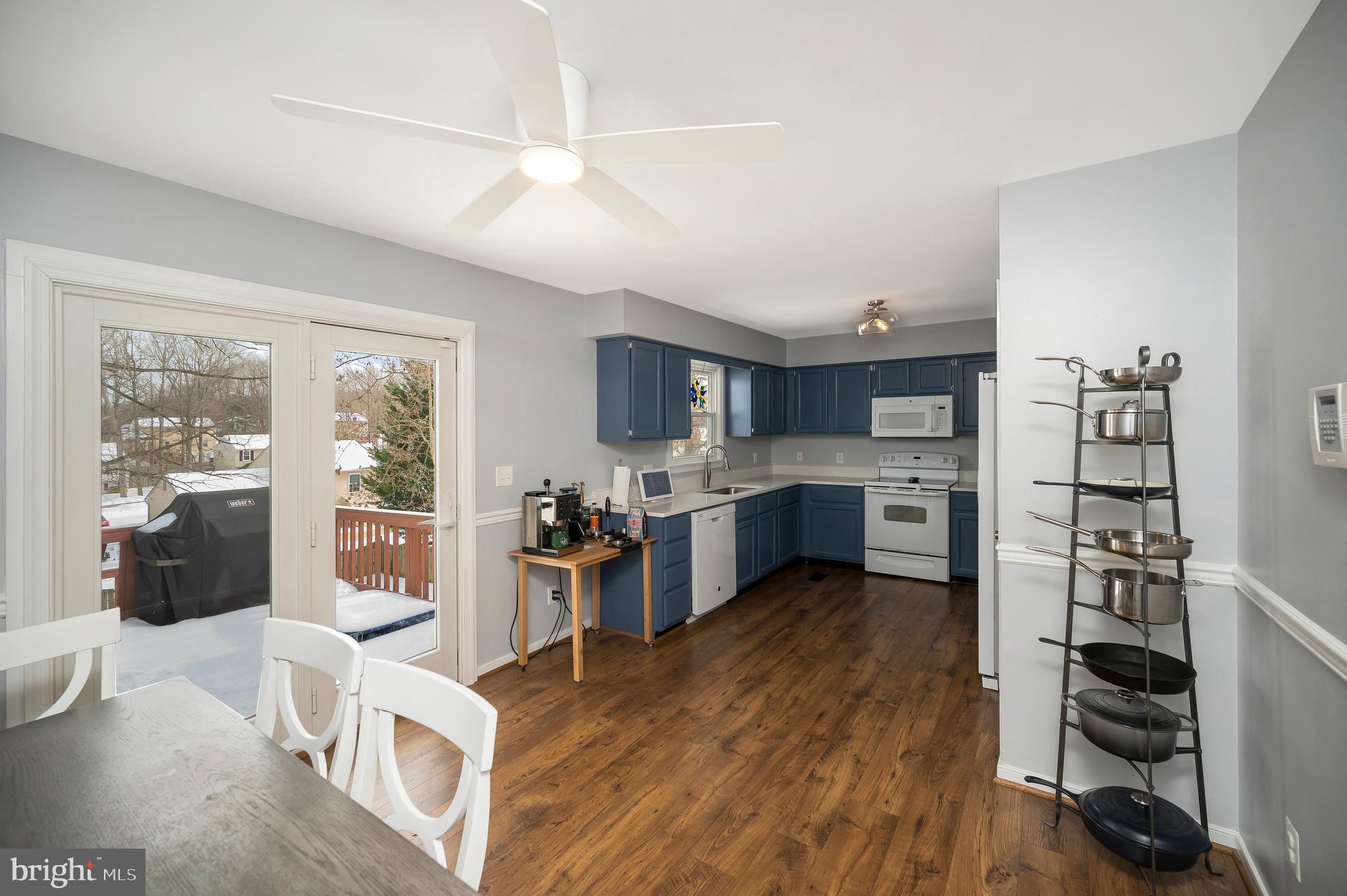 228 Choptank Road Stafford, VA 22556 - Photo 12 of 56 a kitchen with stainless steel appliances kitchen island granite countertop a refrigerator oven a sink a dining table and chairs with wooden floor