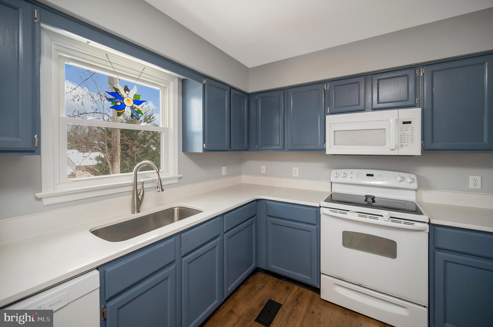 228 Choptank Road Stafford, VA 22556 - Photo 20 of 56 a kitchen with kitchen island a sink cabinets and wooden floor