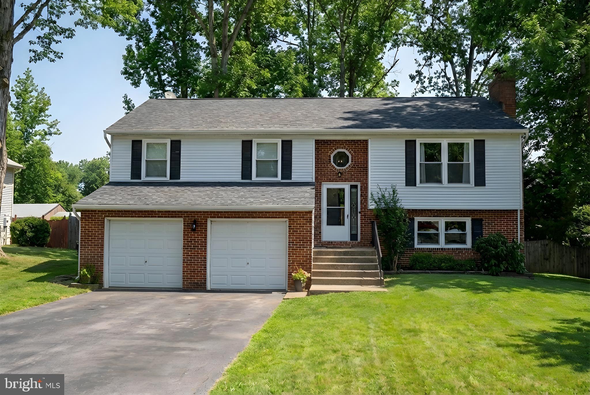 228 Choptank Road Stafford, VA 22556 - Photo 2 of 56 a front view of a house with a garden