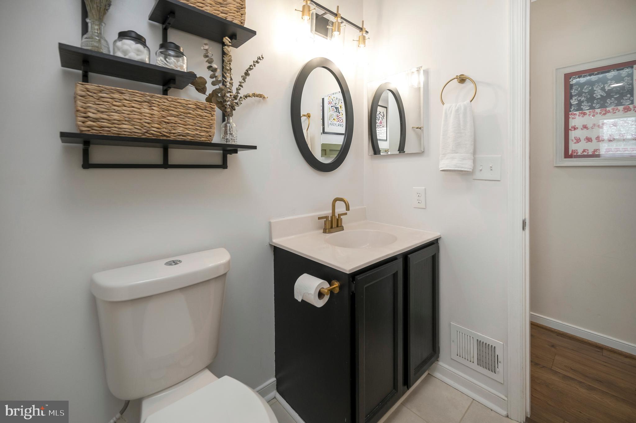 228 Choptank Road Stafford, VA 22556 - Photo 39 of 56 a bathroom with a toilet sink and mirror