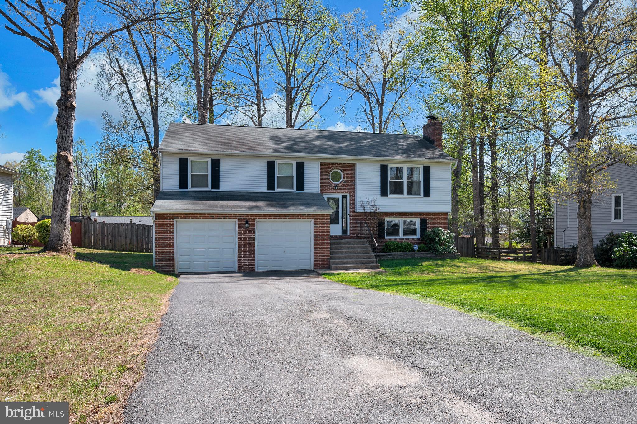 228 Choptank Road Stafford, VA 22556 - Photo 46 of 56 a front view of a house with a yard and garage