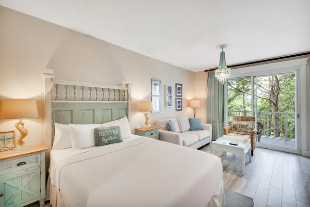 a bedroom with two beds and a large window