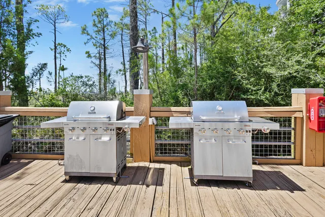 a dining hall with stainless steel appliances granite countertop a sink a stove and a refrigerator