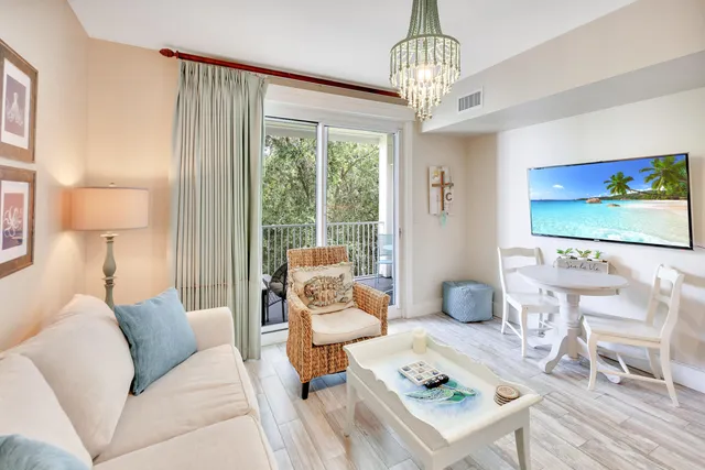 a living room with furniture a dining table and a large window