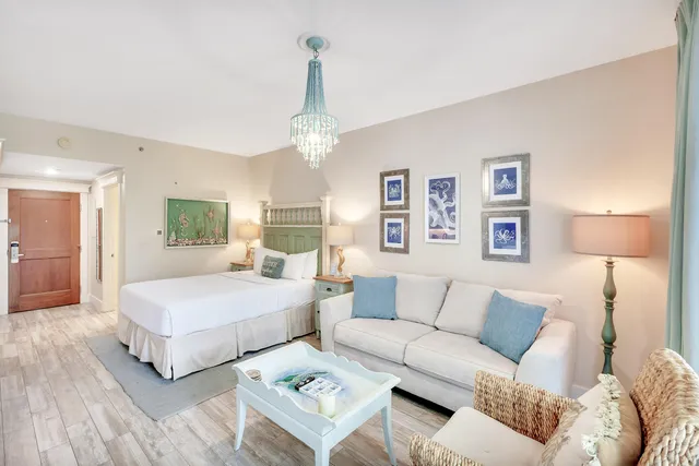 a living room with kitchen island furniture and a chandelier