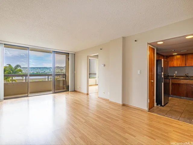 a view of a kitchen with a sink and a refrigerator