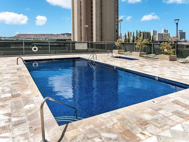 a view of a swimming pool with a lawn chairs