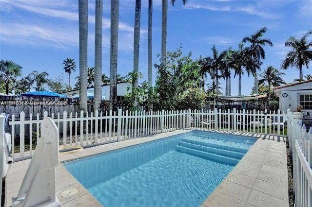 1611 Mayo Street Hollywood, FL 33020 - Photo 3 of 20 a view of a chairs on wooden deck