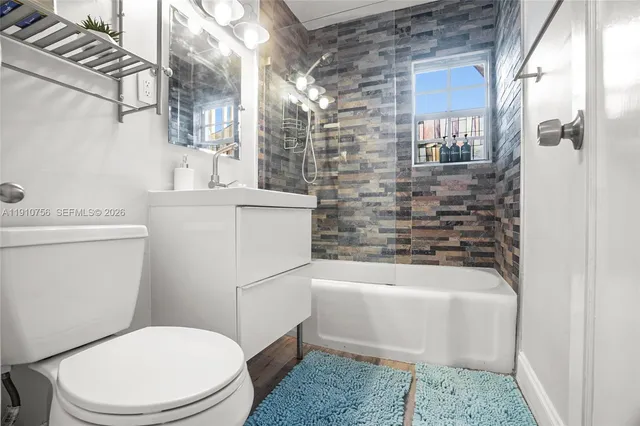 a bathroom with a toilet a sink and bathtub