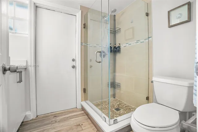 a bathroom with a toilet and a shower