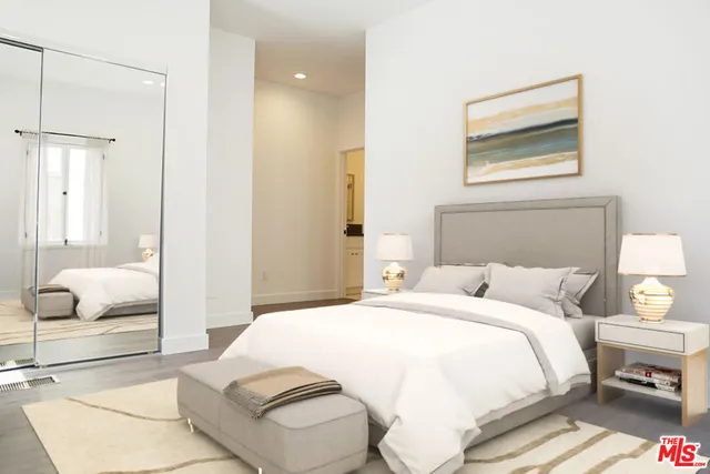 a bedroom with a bed and a painting on the wall