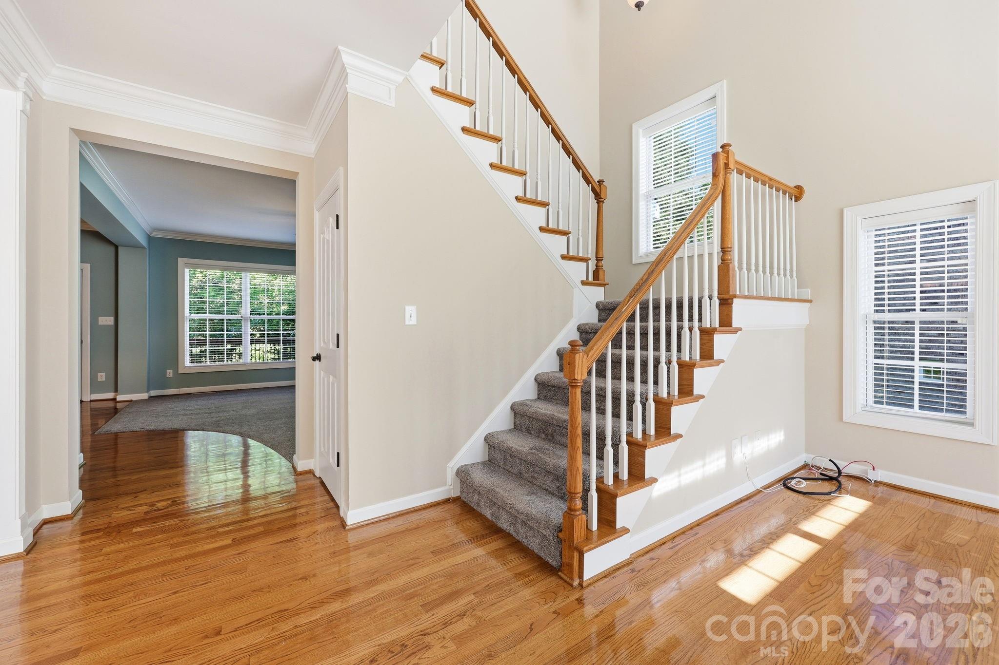 3308 Grandeur Road Charlotte, NC 28269 - Photo 5 of 45 a view of a hallway with wooden floor and staircase