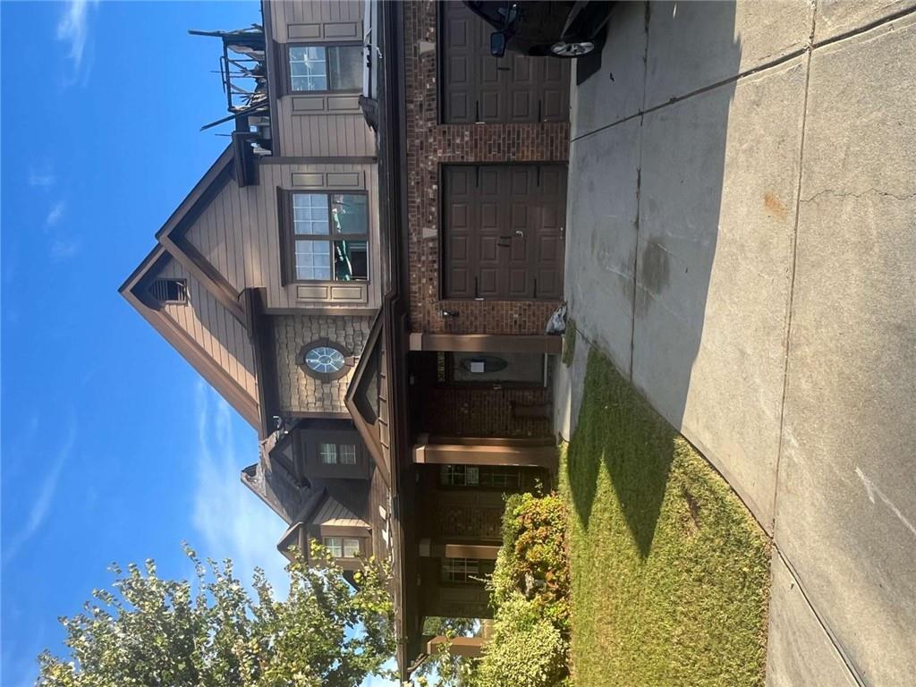 a front view of a house with a garden and plants