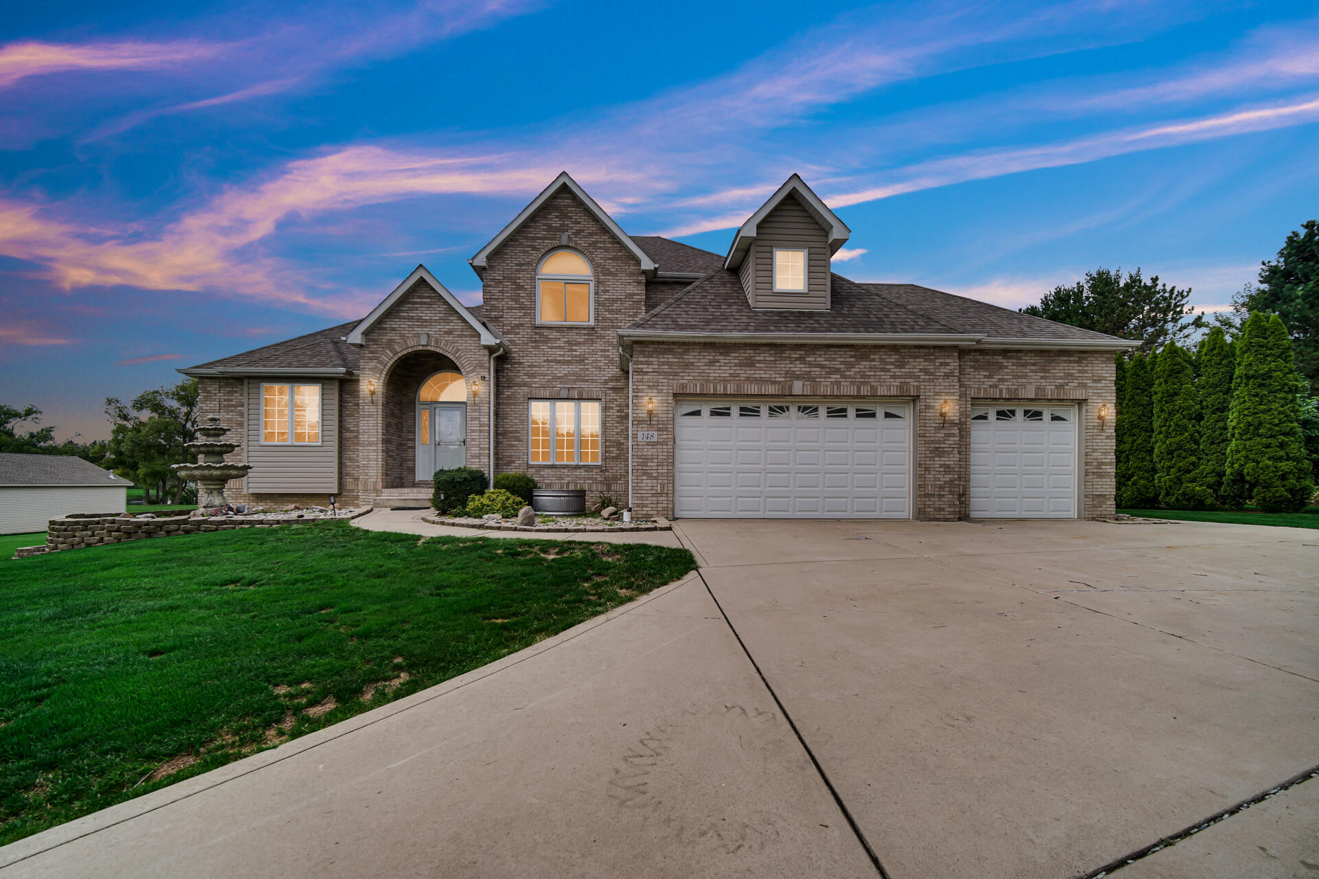 a front view of a house with a yard and garage