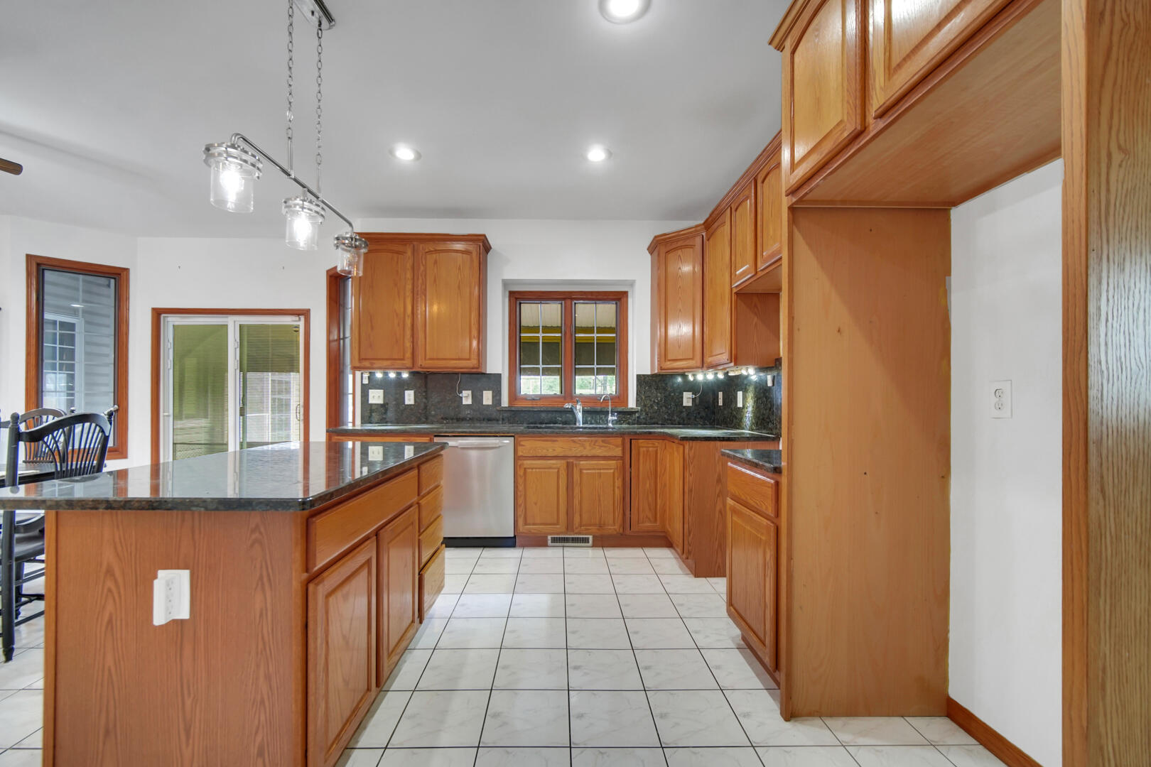 148 Timber Point Court Valparaiso, IN 46385 - Photo 12 of 30 a kitchen with stainless steel appliances granite countertop a refrigerator a sink dishwasher with a dining table and chairs